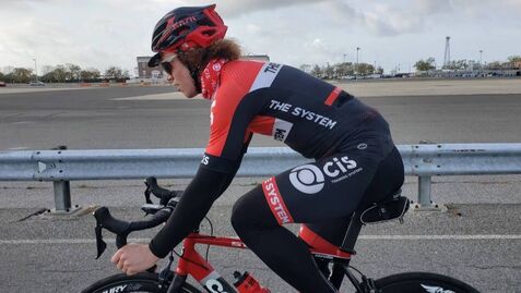 CIS Training Systems Athlete cycling in the his drops preparing for an attach out of the saddle.