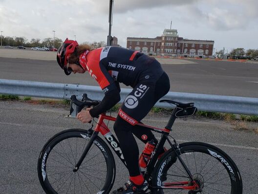 CIS Training Systems athlete sprinting out of the saddle on a Motopacing Training Ride.